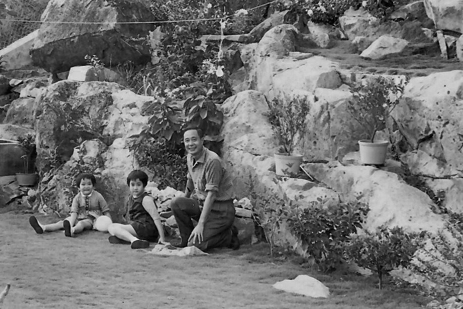 Black and white childhood photo of architect Annie Chu with sister and father