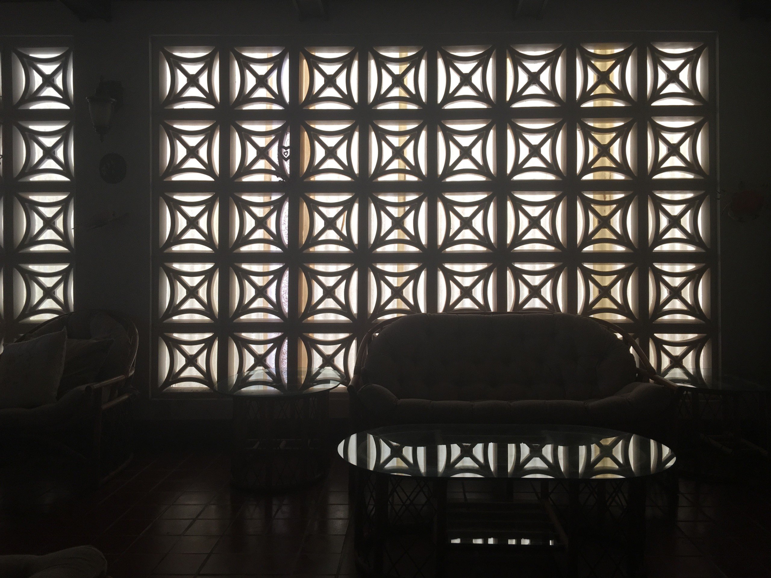 Breeze blocks creating stark contrast between light and dark in artist Edra Soto's childhood home