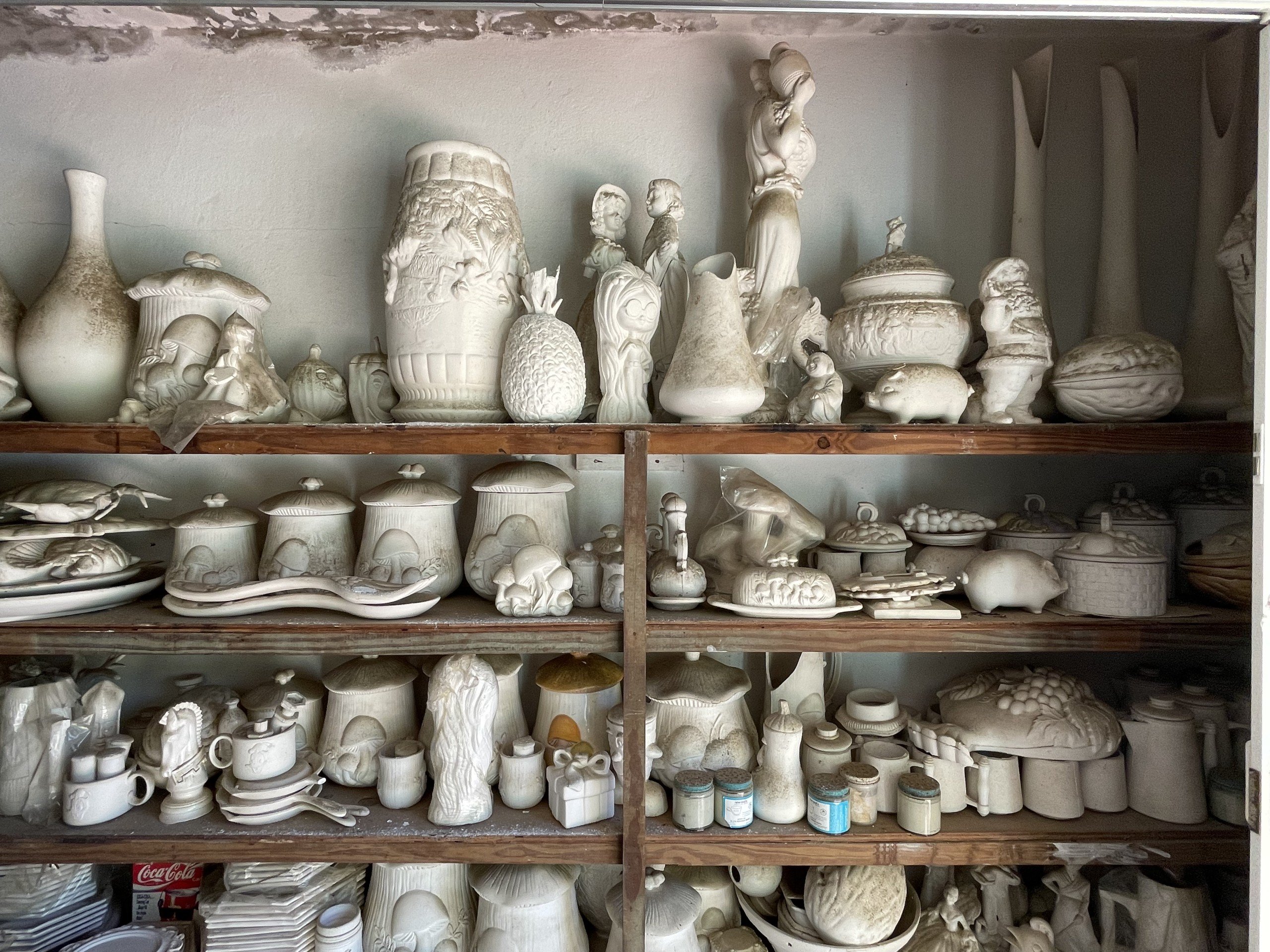 Many unfired ceramics on shelves in artist Edra Soto's childhood home