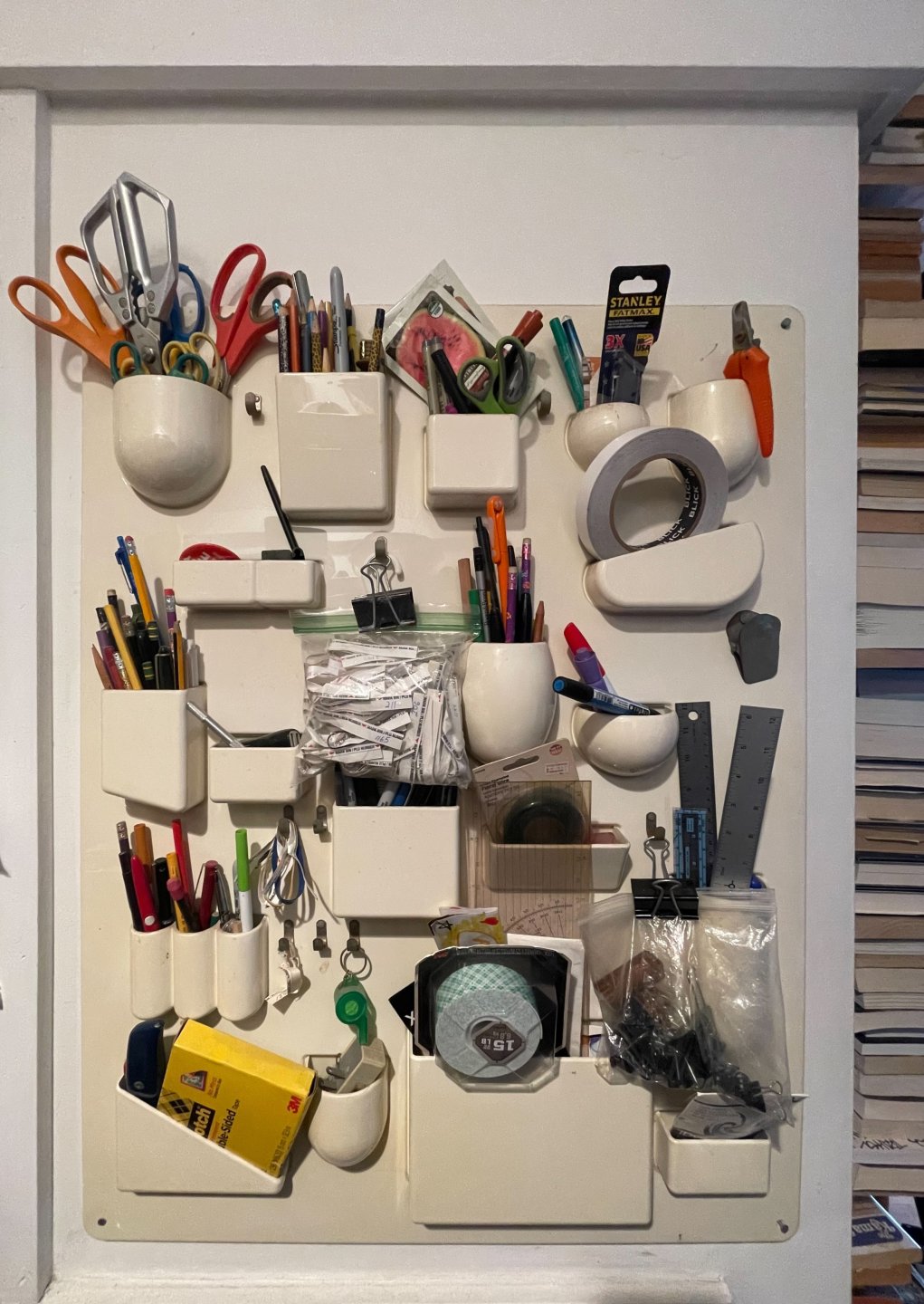 Uten Silo board filled with colorful writing utensils and other office supplies