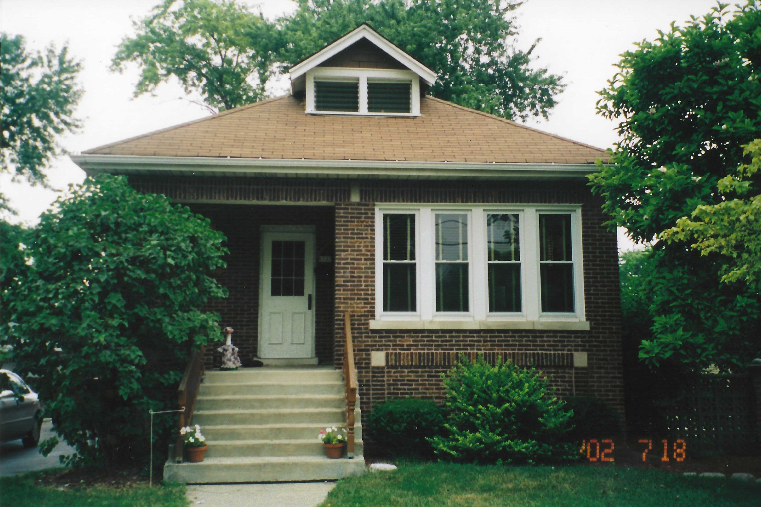 Jonathan Nesci childhood home exterior brown brick bungalow