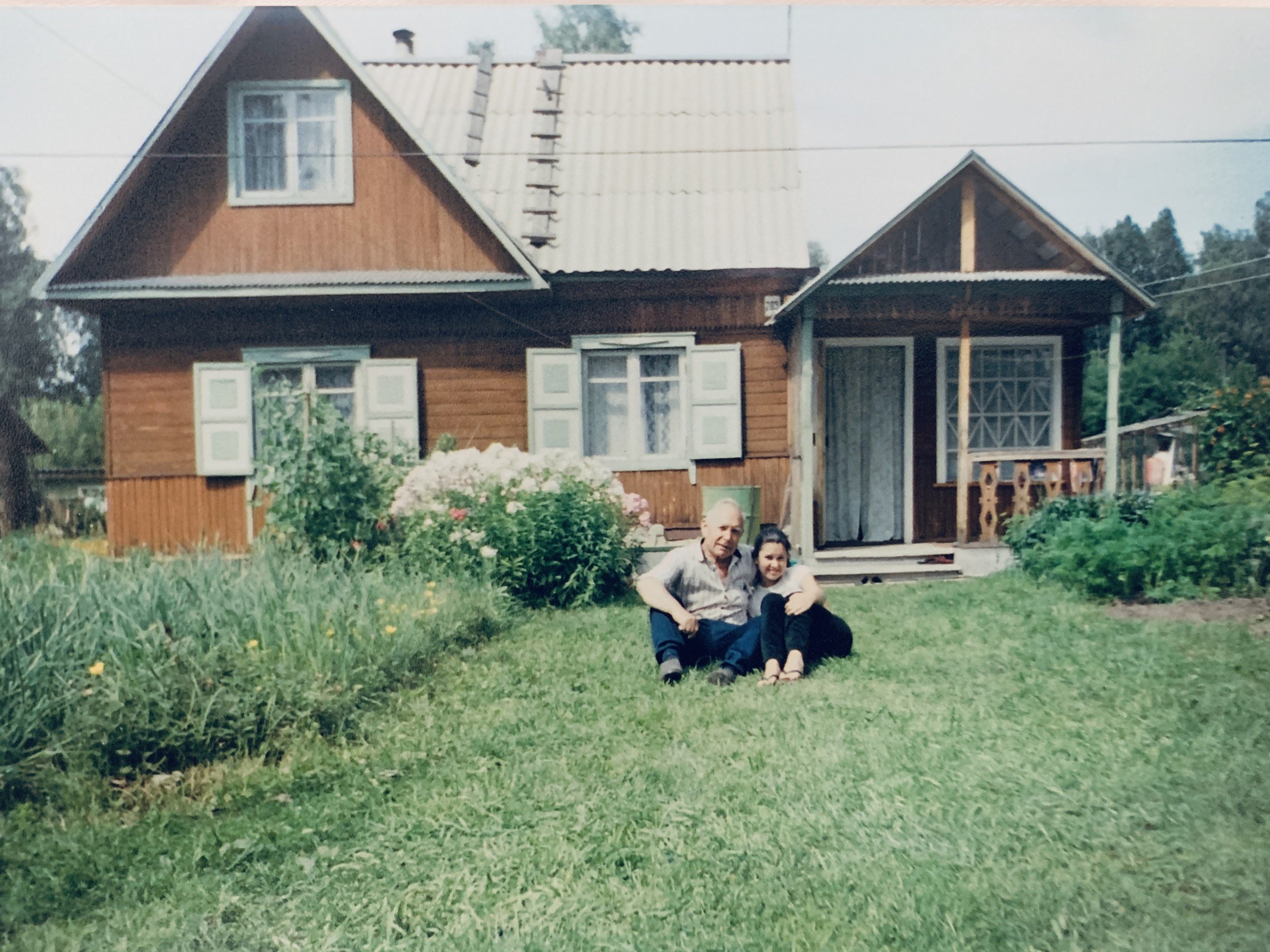 Julia Gamolina and her grandfather sitting outside the dacha he built