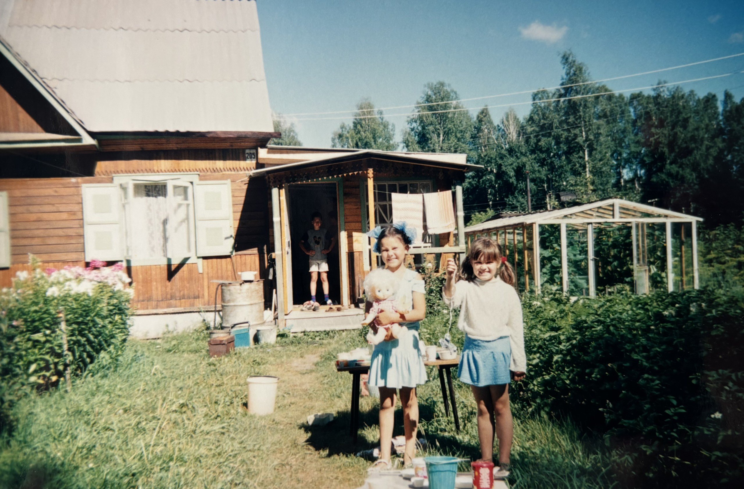 Julia Gamolina as a child with friend near garden outside of dacha