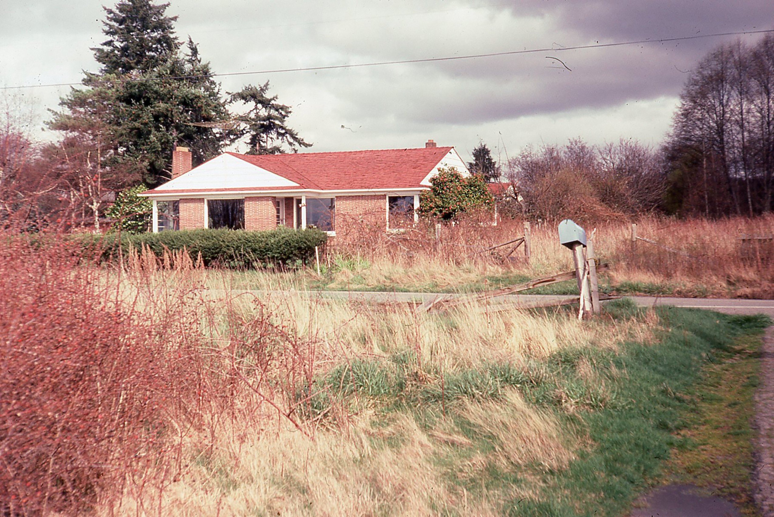 Small brick house in field of grass on Washington State’s Whidbey Island