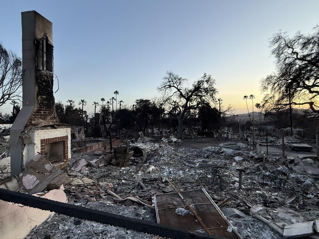 The remnants of artist Kenturah Davis's home after the Eaton Fire, with only the chimney standing