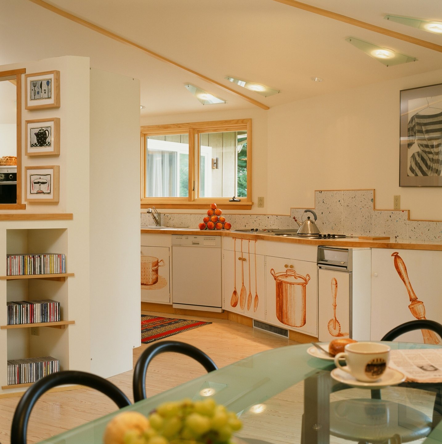 Usonia kitchen with artwork on the white cabinets