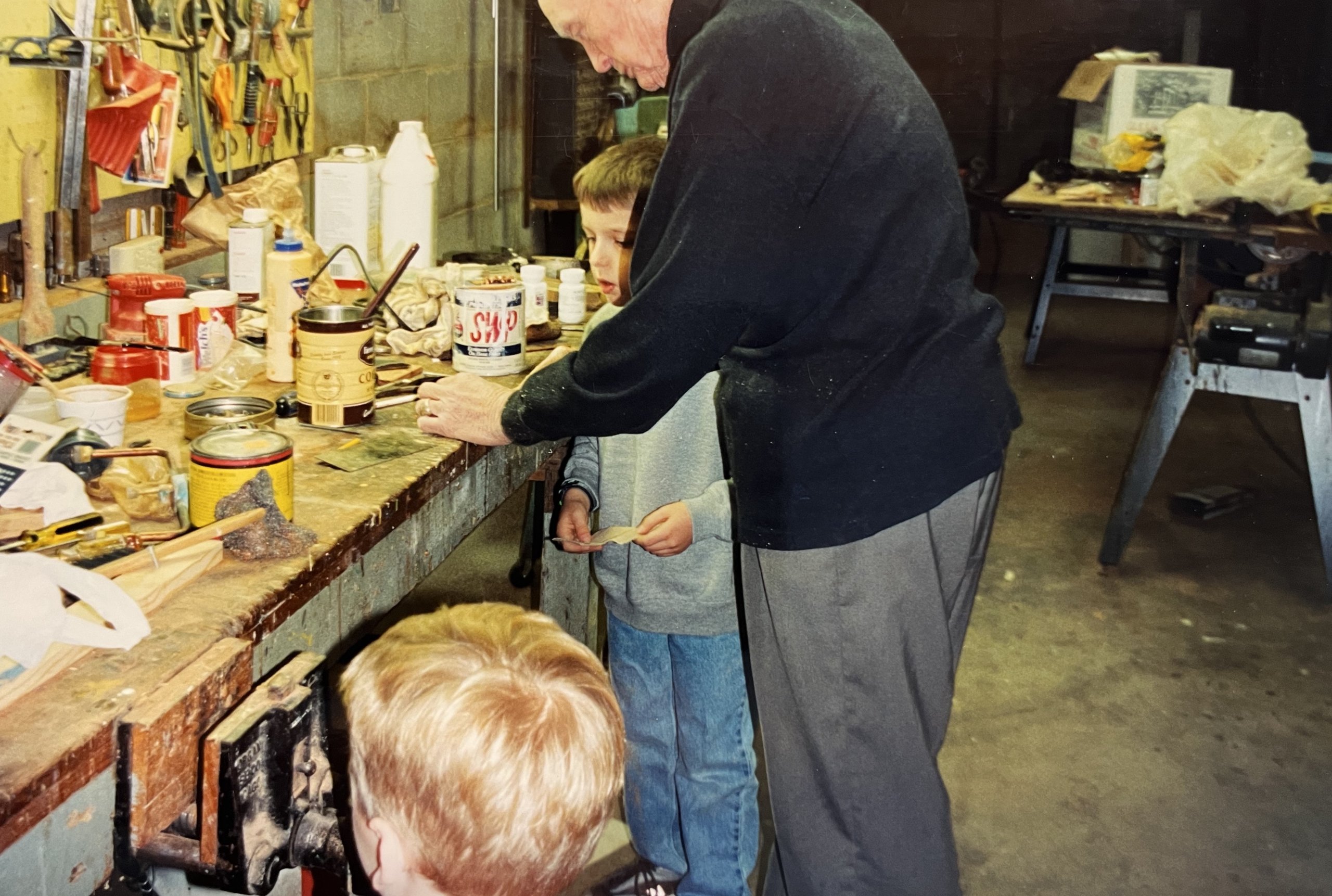 Childhood photograph of writer Charlie Weak with his maternal grandfather in his workshop garage in Juniata, Nebraska.