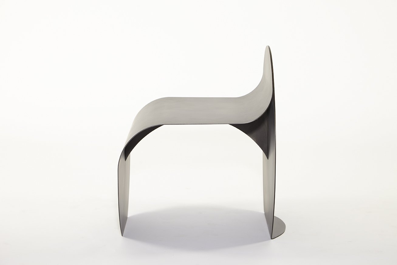 Side view of minimalist gray stool with white background