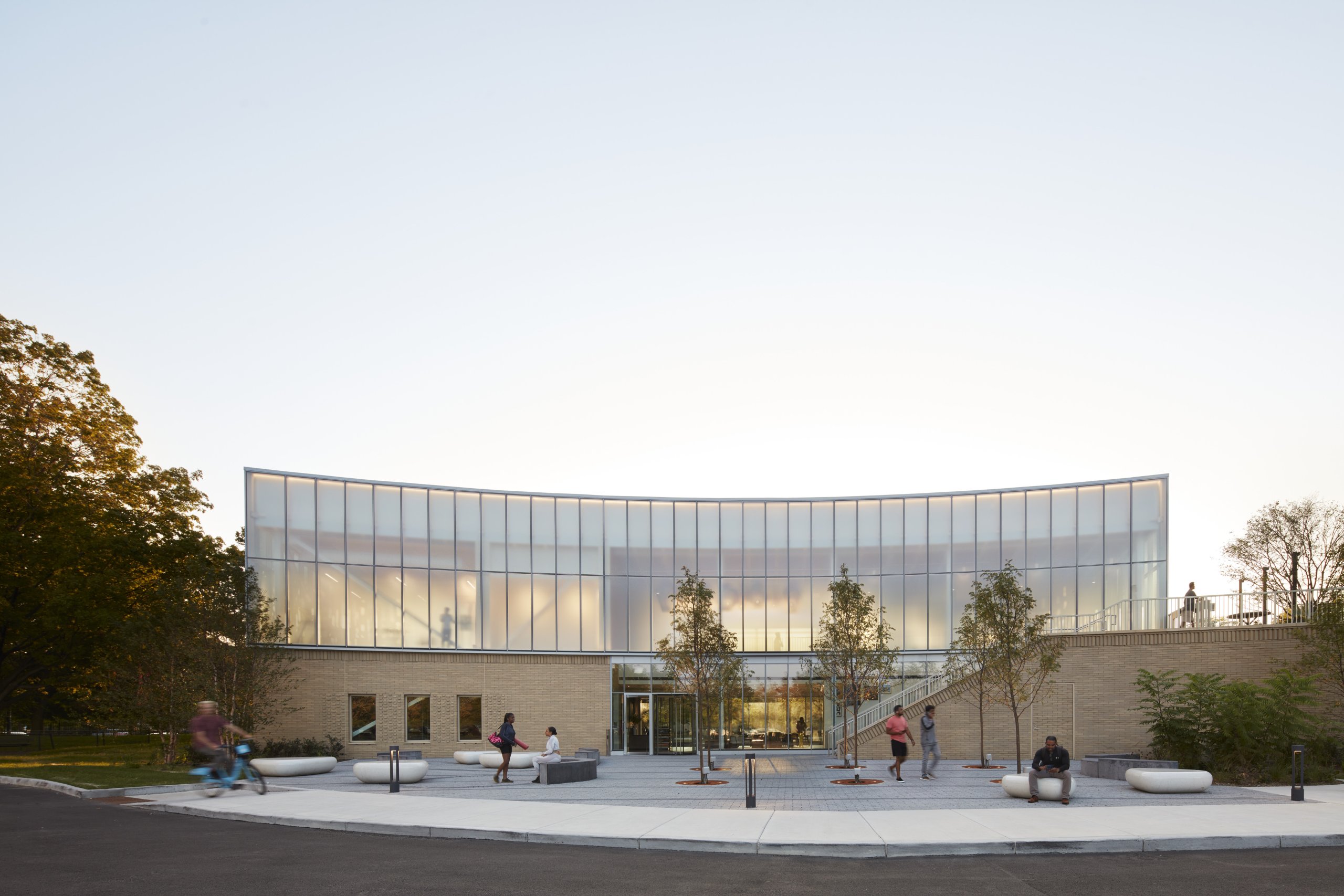 Sunset wide shot of Gensler’s The Hub at Prairie Shores, modern architecture with people outside