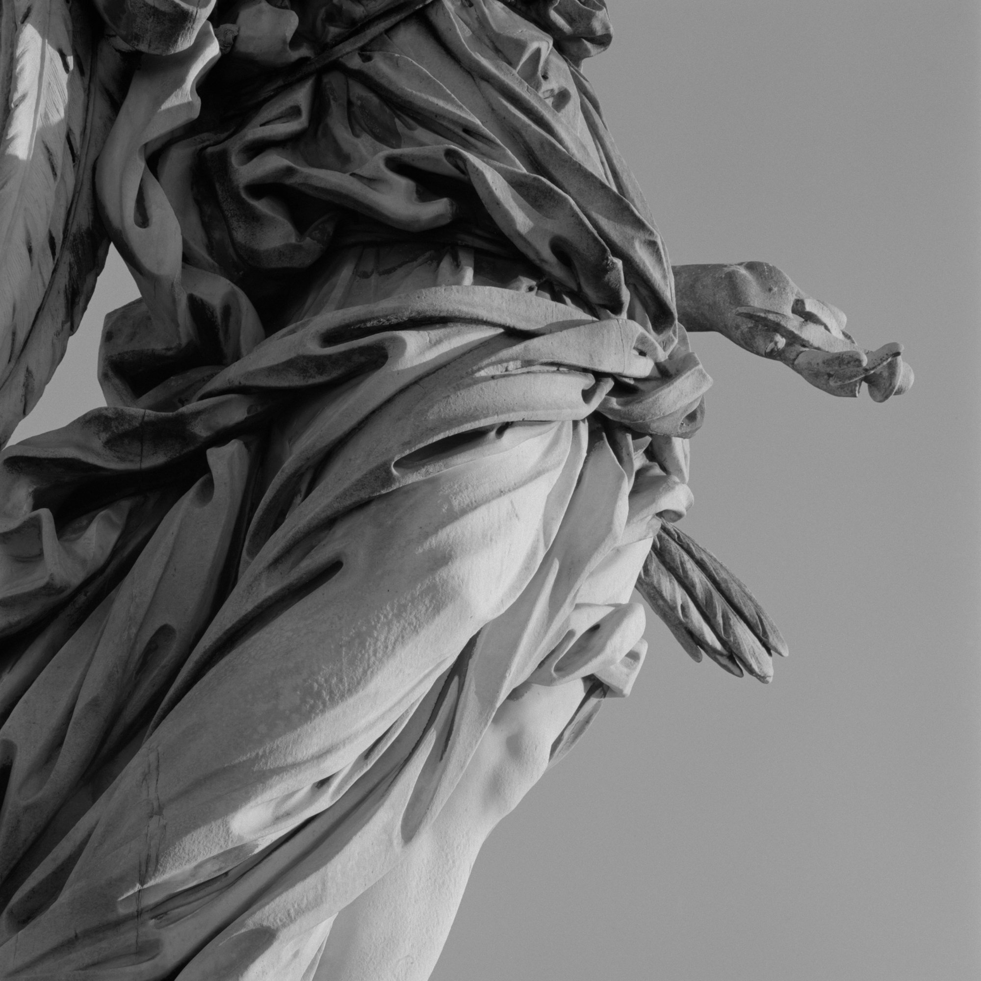 Close-up black and white shot by Hélène Binet of an angel statue