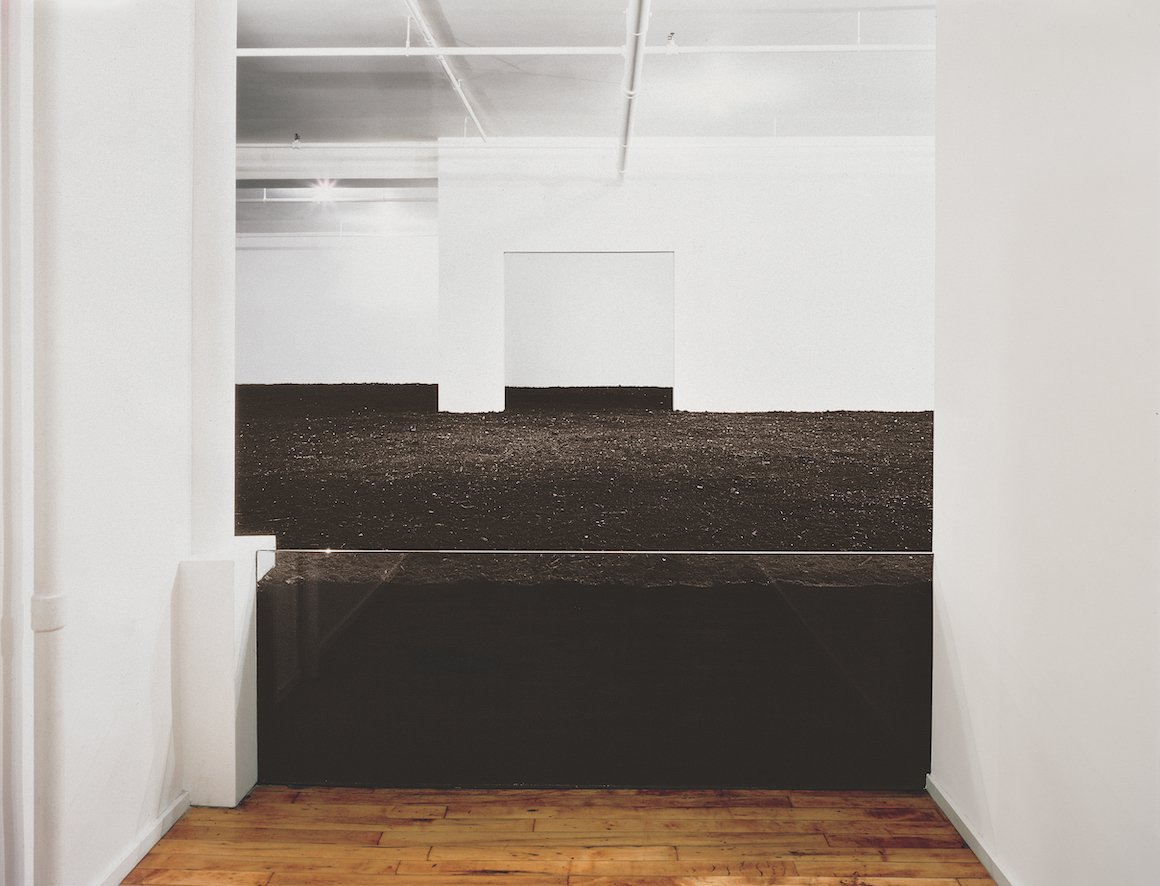 Piles of dirt in a white gallery