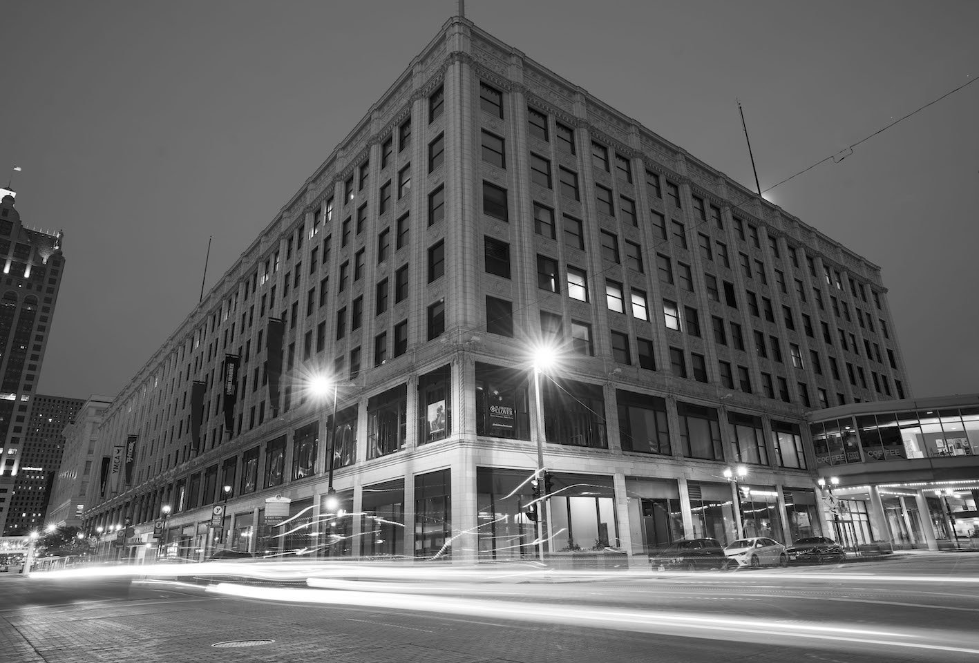 Black and white image of a building on the corner of a street