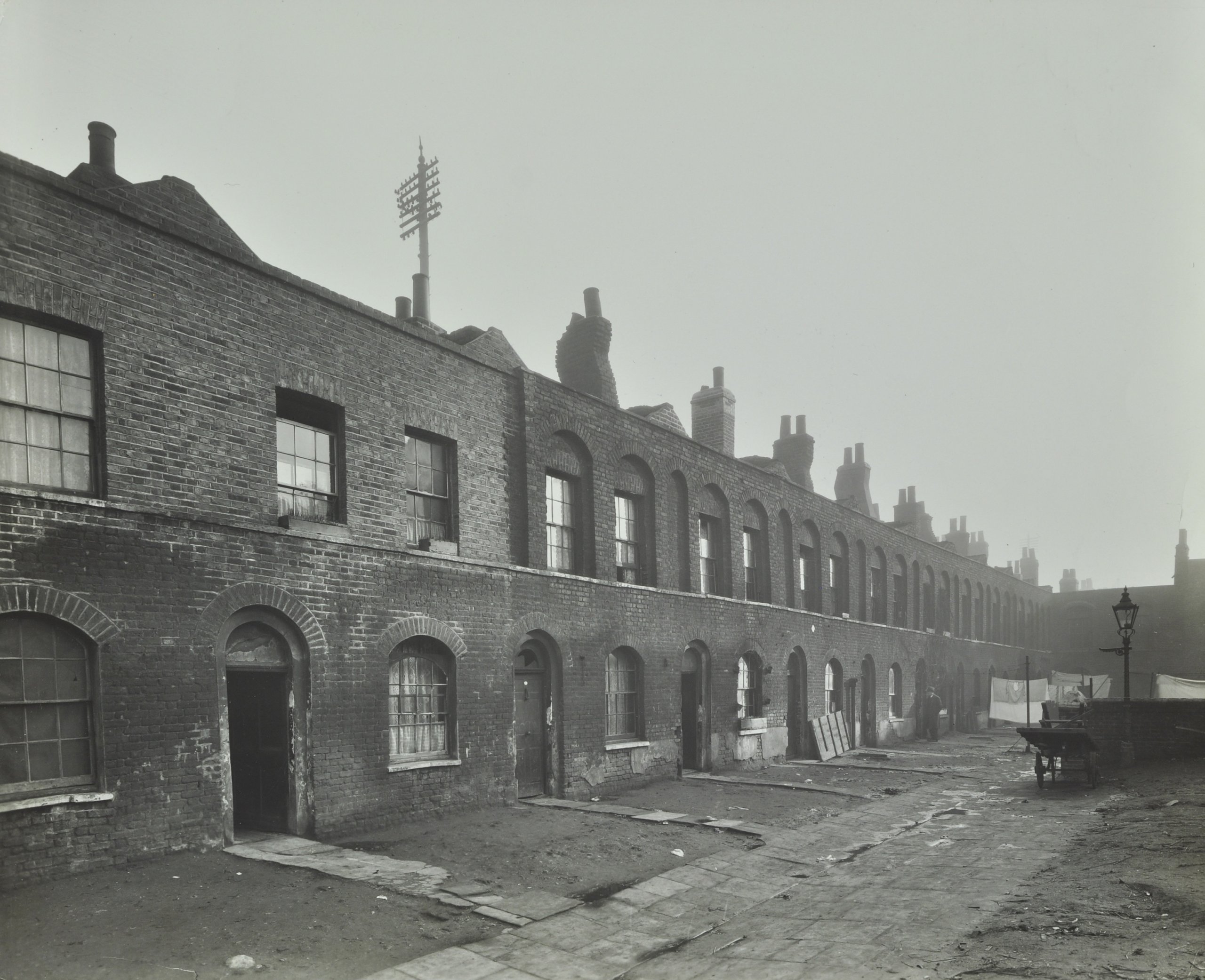 Black and white image of two-story terraced brick houses in 1920s Somers Town