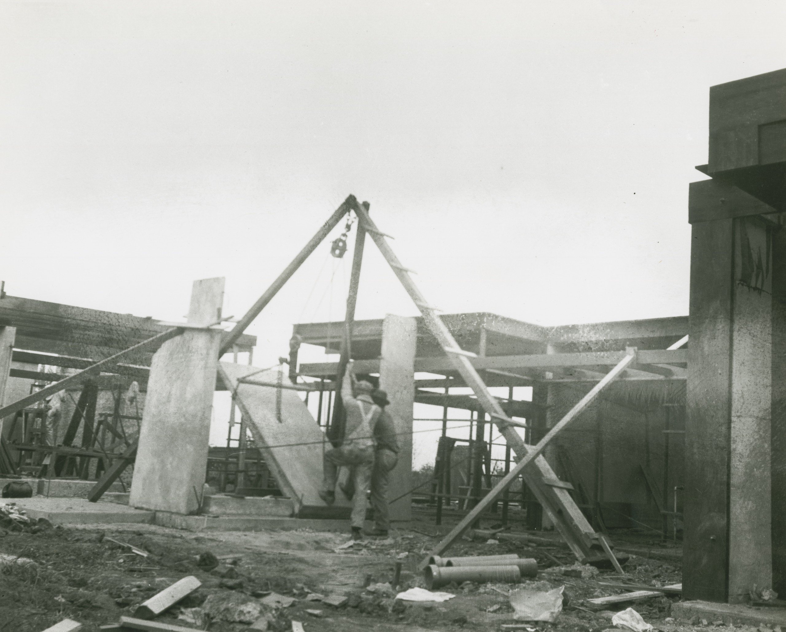 A black and white image of the contruction of a tilt up concrete building